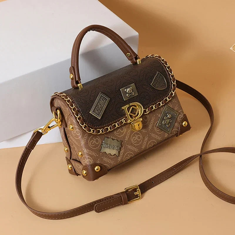 zelda™ – retro shoulder bag with monogram and gold details
